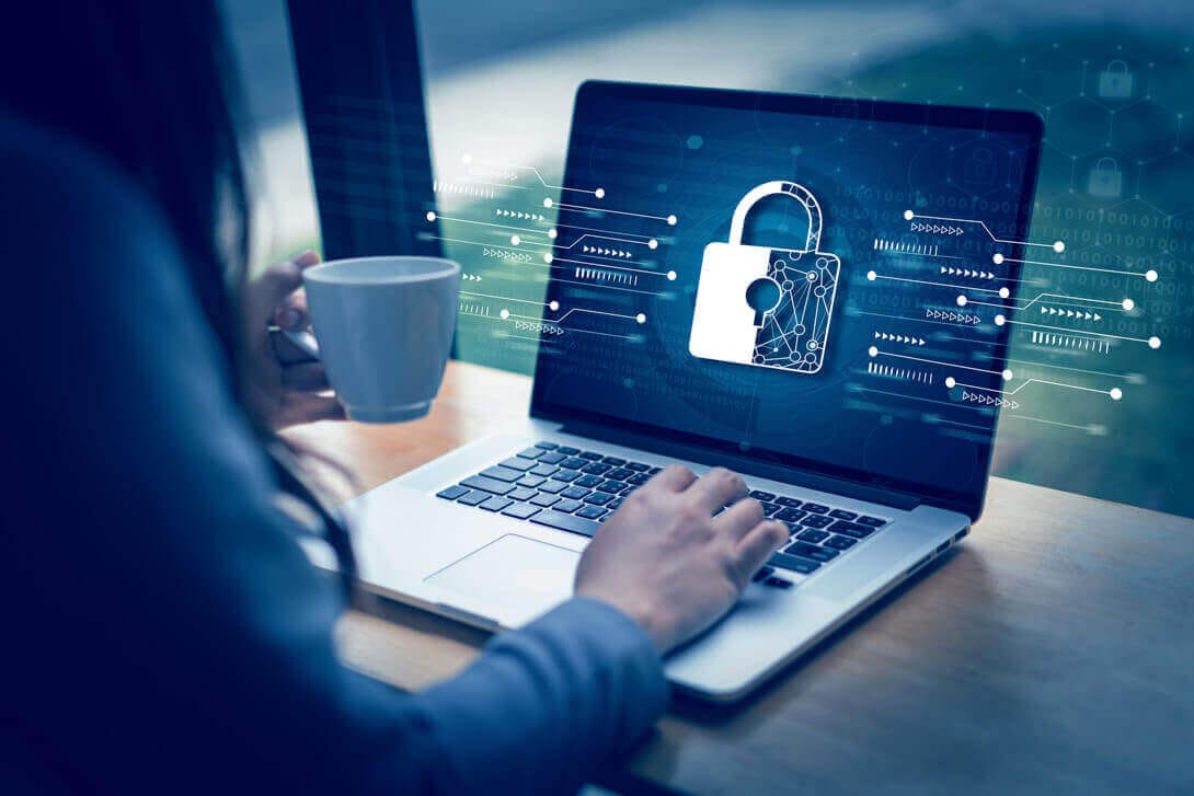 Woman using laptop with lock icon showing Novasys IT data protection